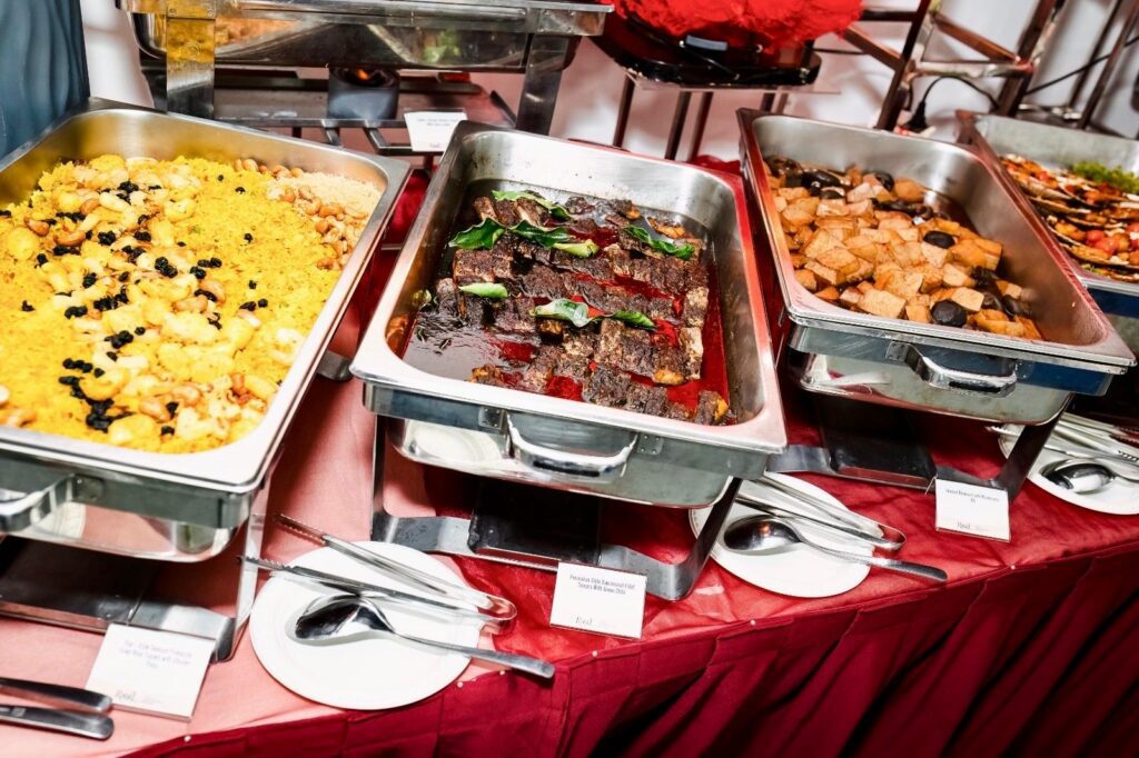Close view of the buffet line, including Thai-style seafood pineapple fried rice and braised beancurd with mushrooms.